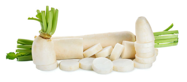 Close-up of chopped radishes against white background