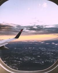 Cropped image of airplane wing over landscape