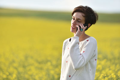 Young woman standing on field