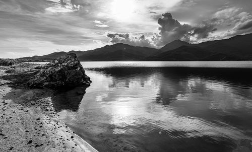 Scenic view of sea and mountains against sky