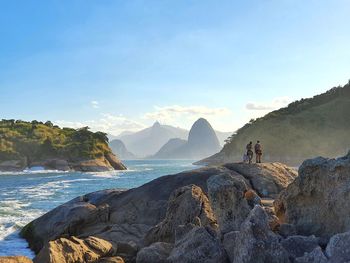 Panoramic shot of rocks in sea against sky