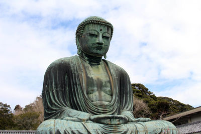 Statue of buddha against sky