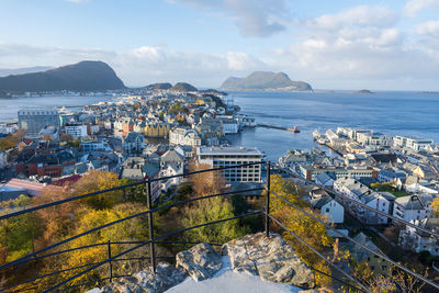 High angle view of buildings by sea against sky