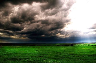Scenic view of landscape against cloudy sky