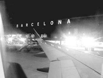 Close-up of airplane in city at night