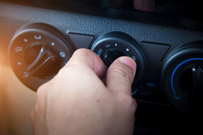 Close-up of human hand holding car