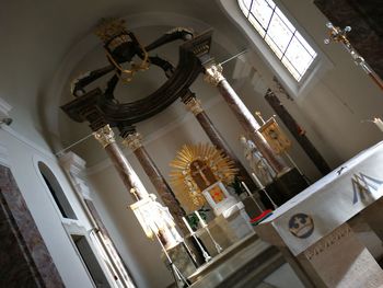 Low angle view of illuminated chandelier hanging in building