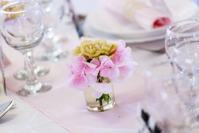 Close-up of flowers in vase on dining table