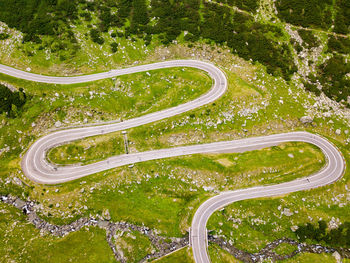 High angle view of winding road amidst trees