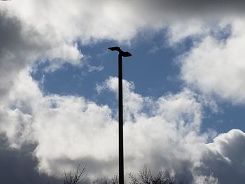 Low angle view of street light against cloudy sky