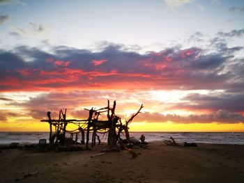 Scenic view of beach against sky during sunset