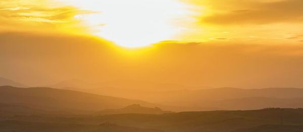 Sunset over a rolling landscape