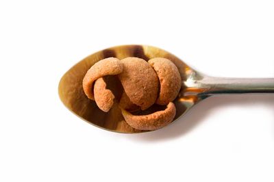 Close-up of bread over white background