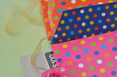 Colorful spotted gift card boxes with ribbons and name tags