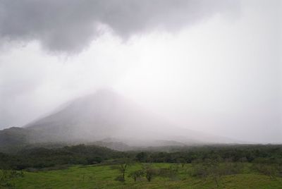 Scenic view of mountains against cloudy sky