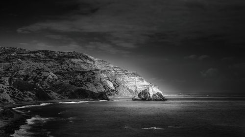 Scenic view of sea against cloudy sky