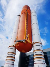 Low angle view of industrial building against sky