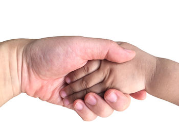 Close-up of hands over white background