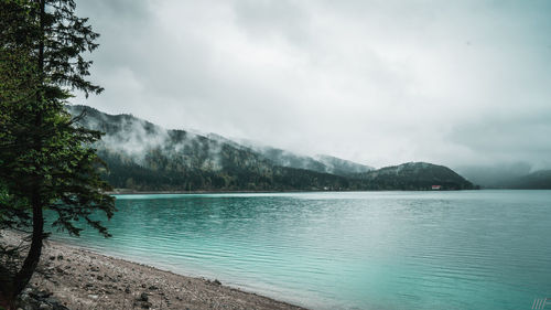 Scenic view of lake and mountains against sky