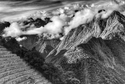 Scenic view of mountains against cloudy sky