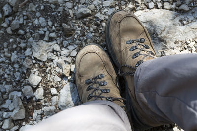 Low section of man standing on rock