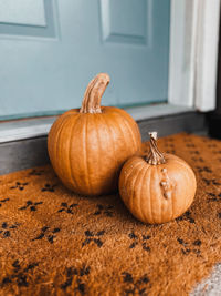 Two pumpkins on a doorstep