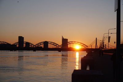 Bridge over river at sunset