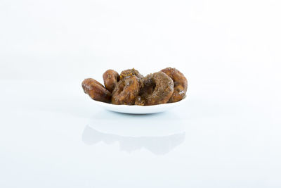 Close-up of bread against white background