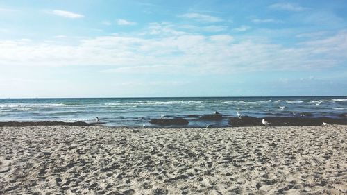 Scenic view of sea against cloudy sky