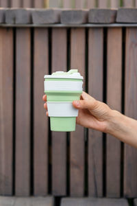 Eco friendly, a young and confident woman holding biodegradable cup thermos for coffee or tea