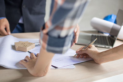 Midsection of man working on table