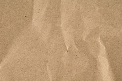 High angle view of paper on beach