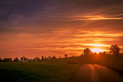 Scenic view of field against sky during sunset