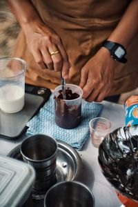 Midsection of woman preparing food on table