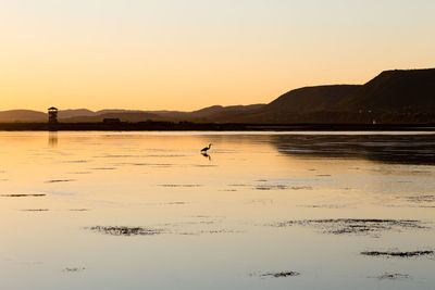 Scenic view of lake against sky during sunset