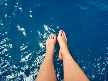 Low section of woman feet in swimming pool