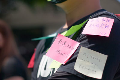 Close-up of woman holding paper with text