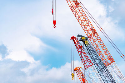 Crawler crane against blue sky and white clouds. real estate industry. red crawler crane use lift 