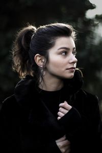 Close-up of thoughtful young woman looking away outdoors