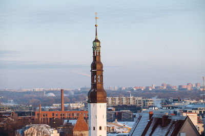 Tower in city against sky
