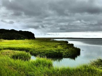 Scenic view of sea against cloudy sky