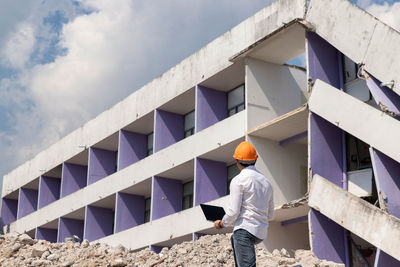 Low angle view of man standing against building