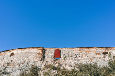 Low angle view of building against blue sky