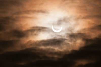 Low angle view of moon in sky at sunset