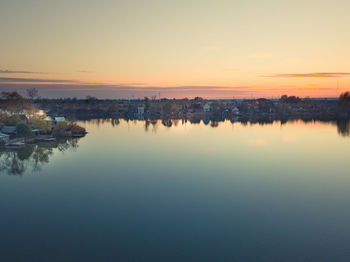 Scenic view of lake against sky during sunset