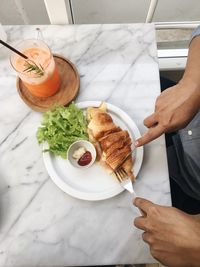 High angle view of man preparing food on table