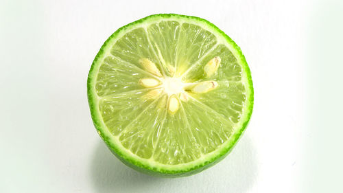 Close-up of lemon slice against white background