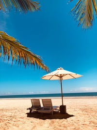 Lifeguard hut on beach against sky