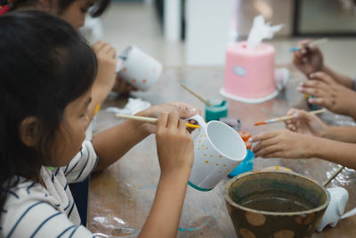 High angle view of people making decoration on table