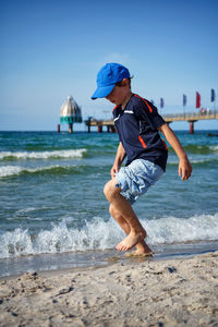 Boy playing at baltic sea beach